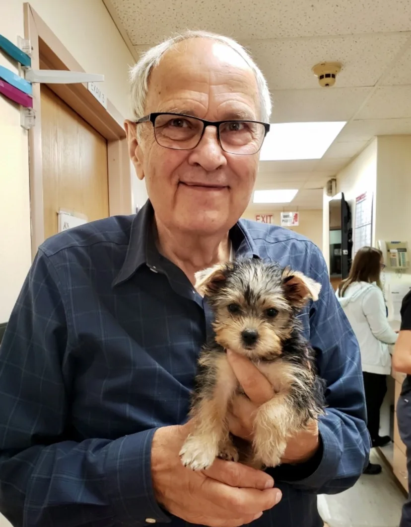 Dr. Anthony C. Burgett holding small puppy